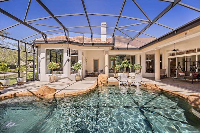 exterior space with stucco siding, a patio, a ceiling fan, and a tile roof