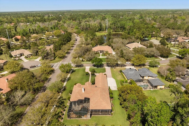 aerial view with a wooded view and a residential view