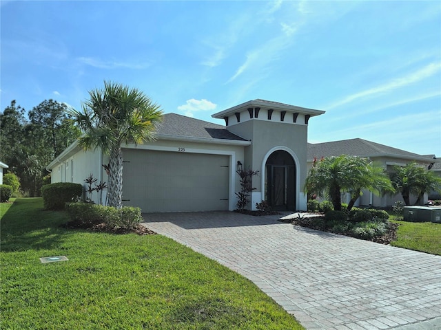 view of front of property with stucco siding, an attached garage, decorative driveway, and a front lawn