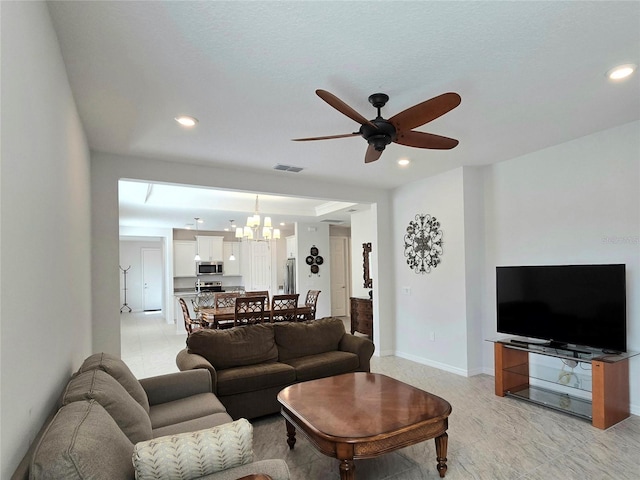 living area with recessed lighting, ceiling fan with notable chandelier, visible vents, and baseboards