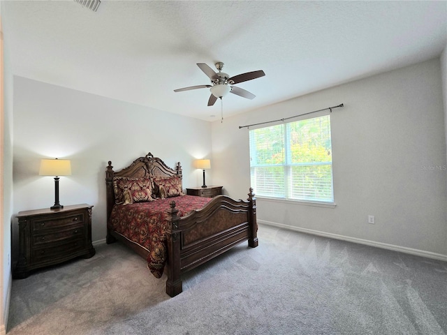 carpeted bedroom with a ceiling fan and baseboards