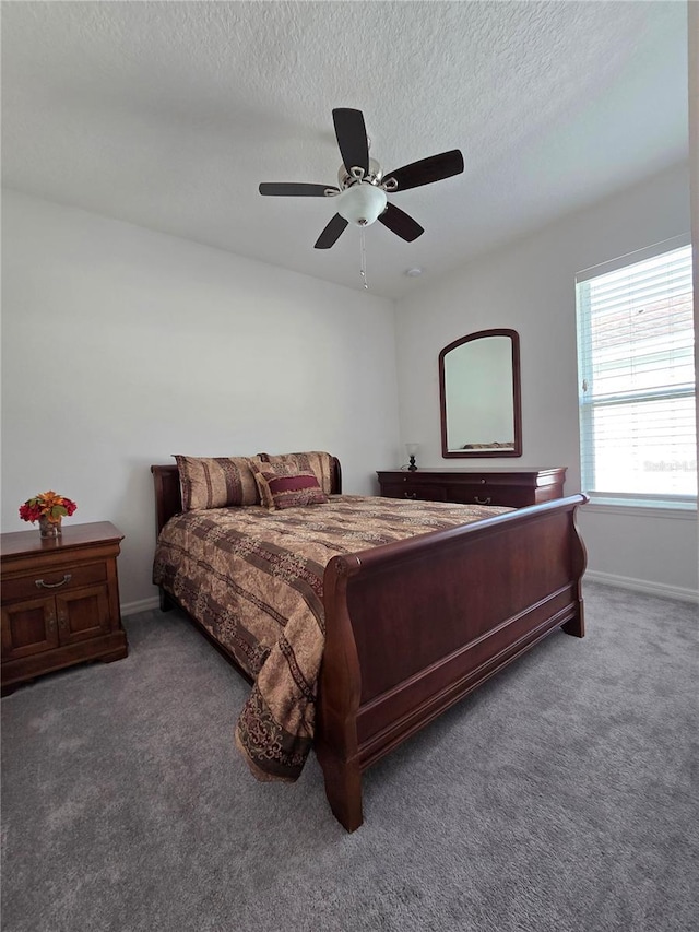 bedroom with carpet, baseboards, and a textured ceiling