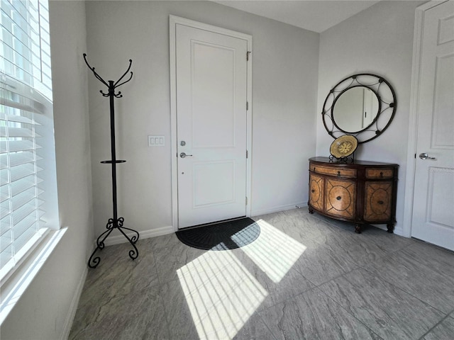 foyer entrance featuring baseboards