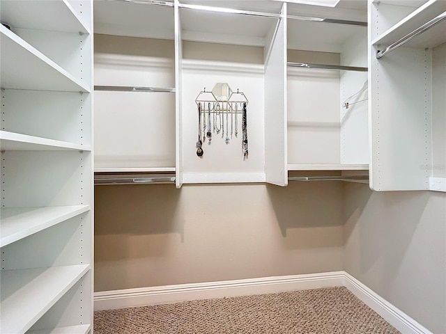 walk in closet with carpet flooring