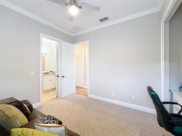 home office with visible vents, light colored carpet, ceiling fan, and ornamental molding