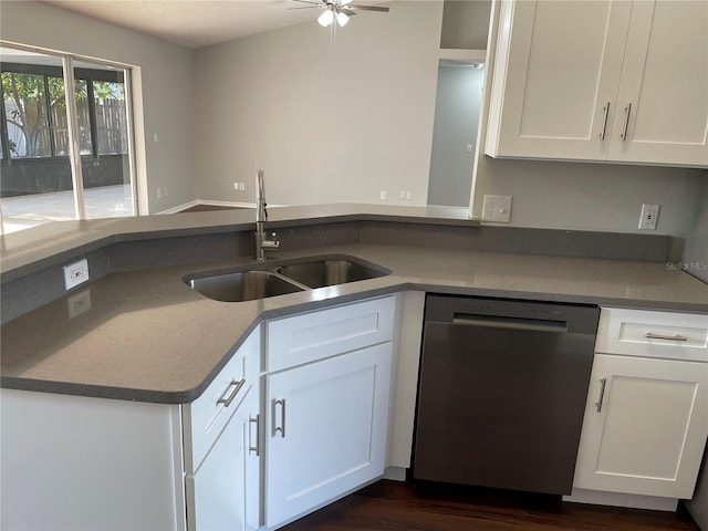 kitchen with ceiling fan, dark wood finished floors, stainless steel dishwasher, white cabinets, and a sink