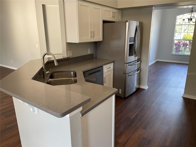 kitchen featuring white cabinetry, a peninsula, a sink, dishwasher, and stainless steel fridge