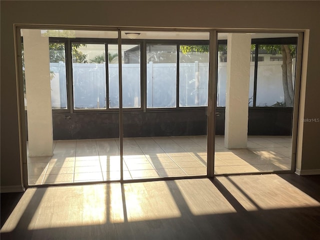 unfurnished sunroom with a wealth of natural light