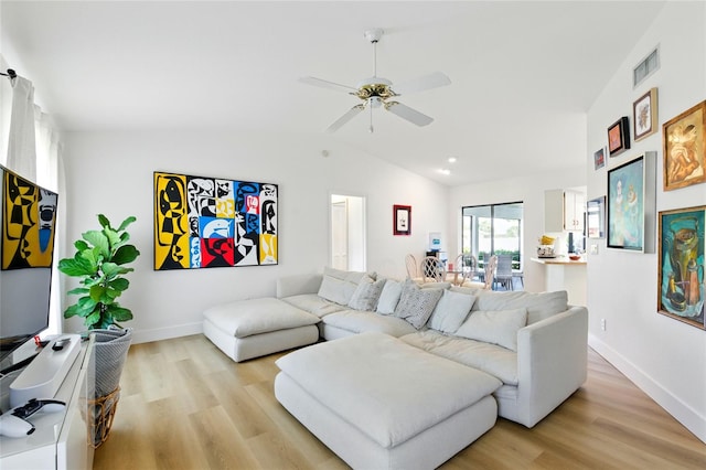 living room with visible vents, ceiling fan, vaulted ceiling, and light wood finished floors