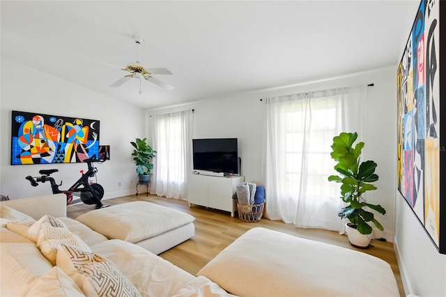 living area with lofted ceiling, wood finished floors, and ceiling fan