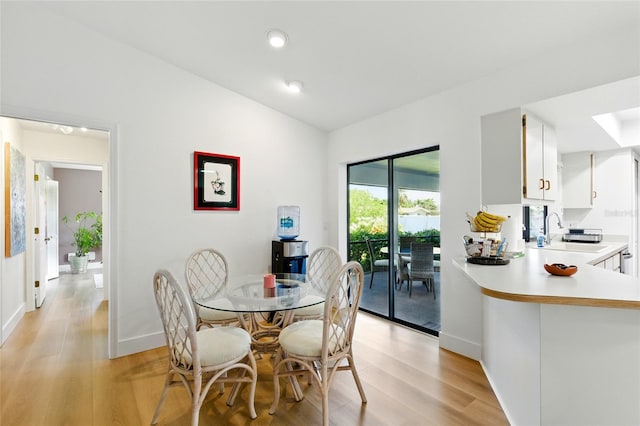 dining area with recessed lighting, baseboards, vaulted ceiling, and light wood finished floors