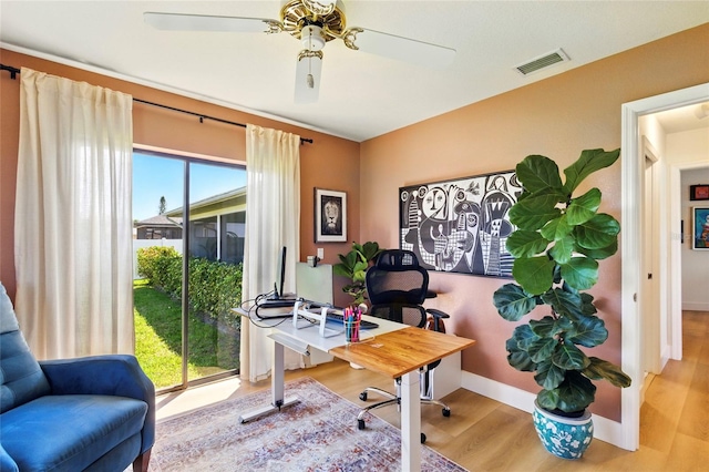 home office featuring visible vents, baseboards, ceiling fan, and wood finished floors