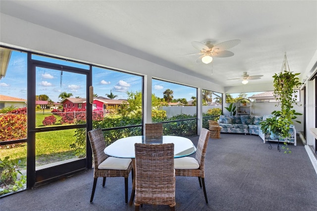 sunroom featuring ceiling fan