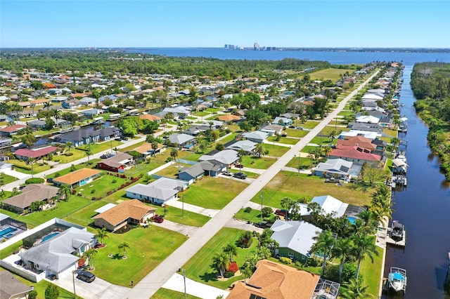 drone / aerial view featuring a residential view and a water view