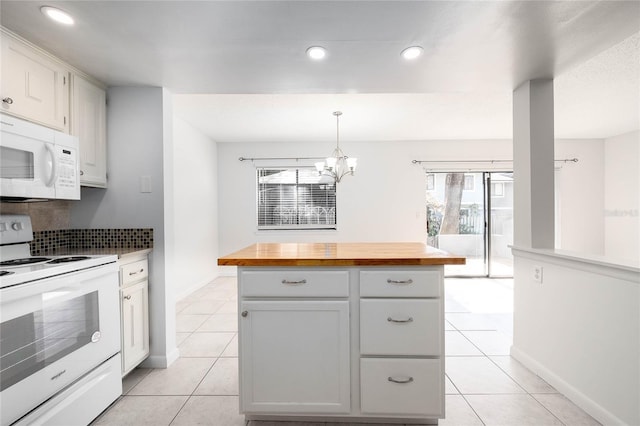 kitchen with wooden counters, light tile patterned floors, recessed lighting, an inviting chandelier, and white appliances