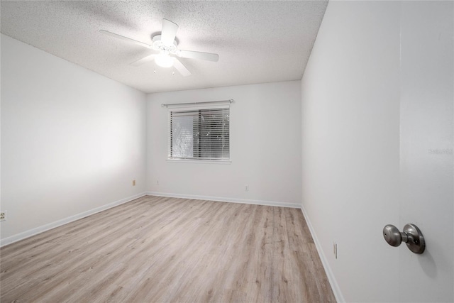 unfurnished room featuring baseboards, a textured ceiling, light wood-style floors, and a ceiling fan