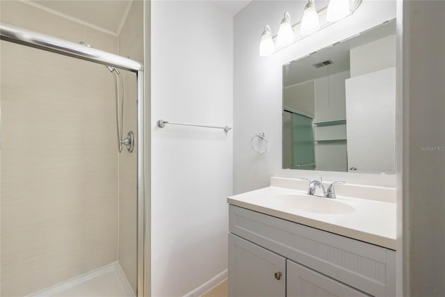 bathroom with visible vents, vanity, and a tile shower