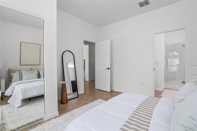 tiled bedroom with visible vents, baseboards, and ensuite bathroom