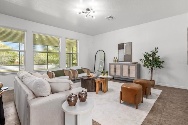 living area featuring a wealth of natural light, visible vents, and baseboards