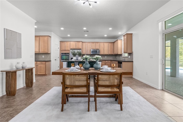 dining space with recessed lighting, baseboards, and light tile patterned flooring