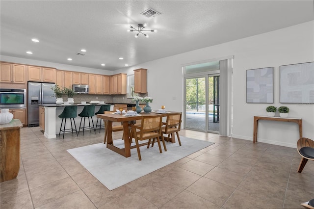 dining room with visible vents, baseboards, recessed lighting, light tile patterned flooring, and a textured ceiling