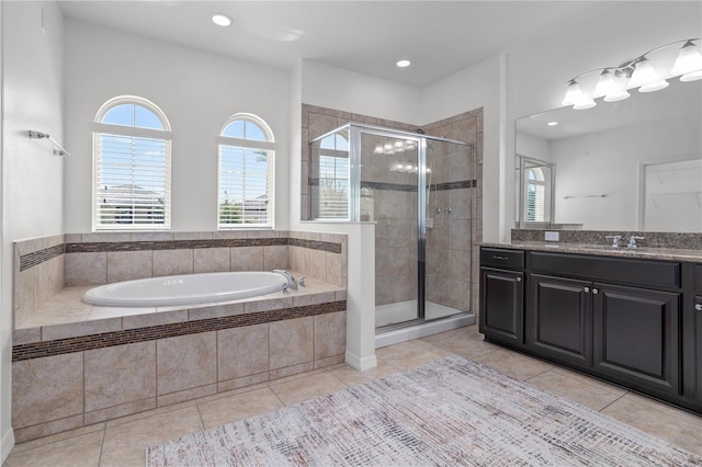 full bath featuring a wealth of natural light, tile patterned flooring, a stall shower, and a garden tub