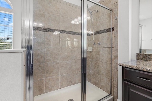 bathroom featuring vanity and a shower stall