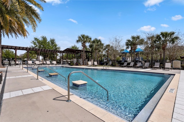 pool featuring a patio area, fence, and a pergola