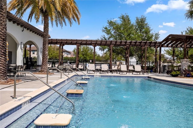 view of swimming pool with a patio area and fence