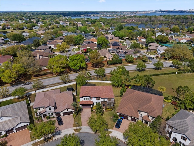 drone / aerial view featuring a residential view and a water view