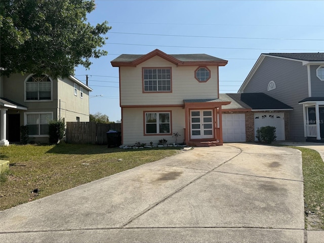 view of front of home with driveway, a front lawn, a garage, and fence