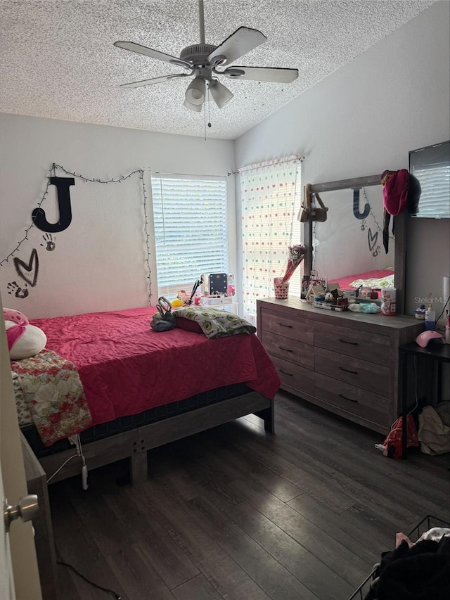 bedroom featuring a textured ceiling, wood finished floors, and a ceiling fan