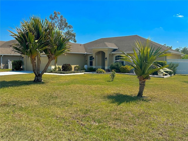 view of front of home featuring stucco siding, fence, concrete driveway, an attached garage, and a front yard