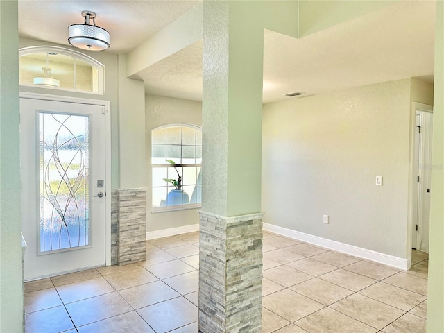 entryway featuring tile patterned flooring, visible vents, and baseboards