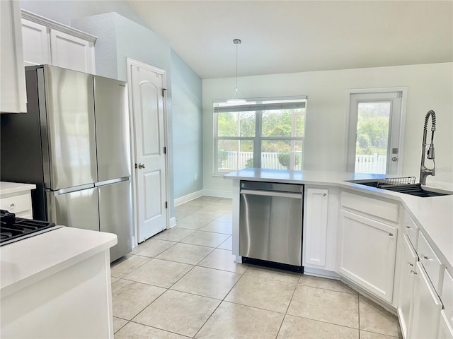 kitchen featuring light countertops, light tile patterned flooring, appliances with stainless steel finishes, and a sink