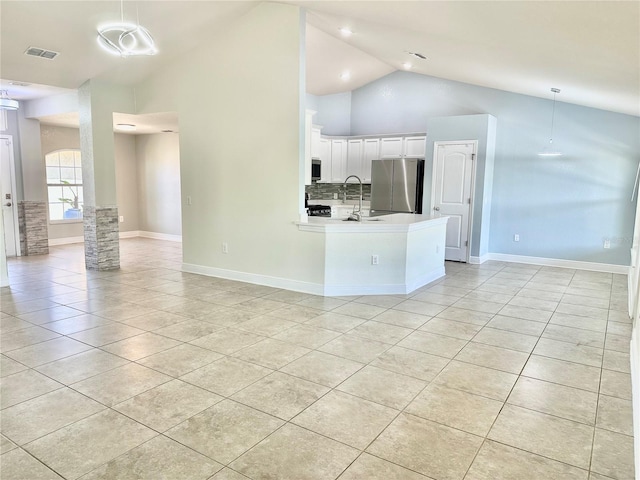 kitchen featuring visible vents, open floor plan, white cabinetry, stainless steel appliances, and light tile patterned floors