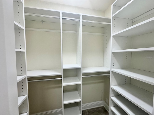 spacious closet with dark tile patterned flooring