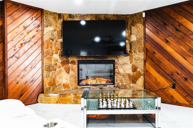 interior details featuring wooden walls and a fireplace