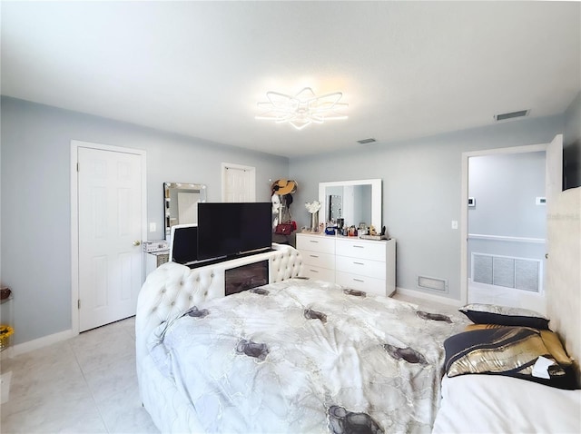 bedroom with light tile patterned floors, visible vents, and baseboards