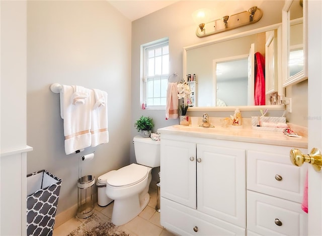 half bath with tile patterned flooring, toilet, and vanity