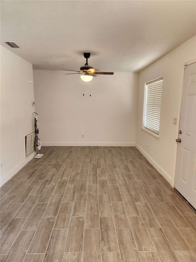 unfurnished living room featuring visible vents, ceiling fan, light wood-style flooring, and baseboards