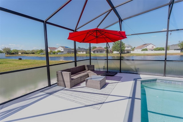 view of swimming pool with an outdoor living space, a water view, a lanai, and a patio area