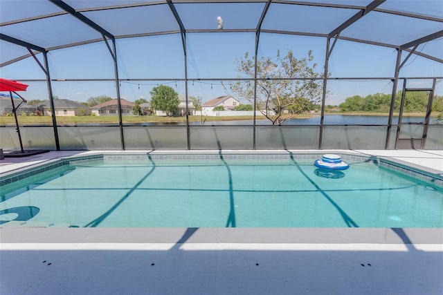 pool featuring a lanai, a patio area, and a water view