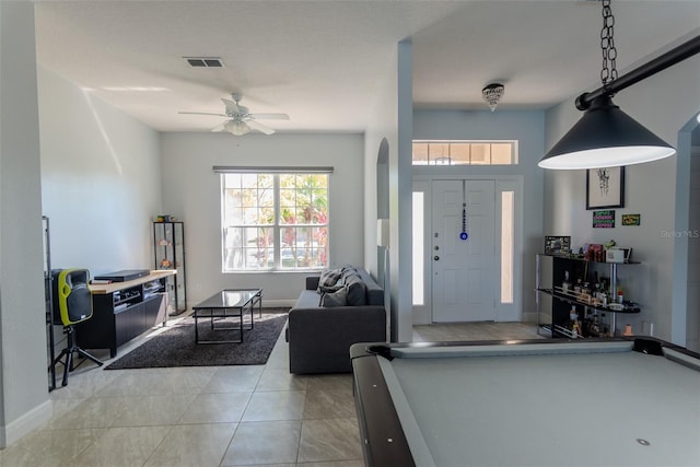 foyer entrance with light tile patterned floors, visible vents, baseboards, and ceiling fan