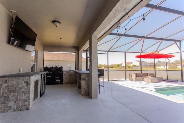 view of patio with outdoor wet bar, an outdoor living space, a lanai, and an outdoor kitchen