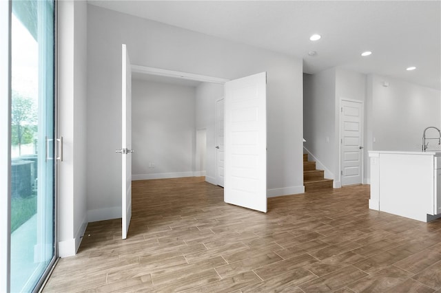 4409 Summer Flowers Pl, Kissimmee, FL 34746 - interior space with stairs, light wood-style flooring, recessed lighting, and baseboards