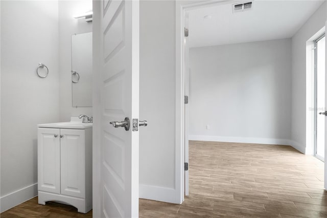 4409 Summer Flowers Pl, Kissimmee, FL 34746 - bathroom with vanity, wood finished floors, visible vents, and baseboards