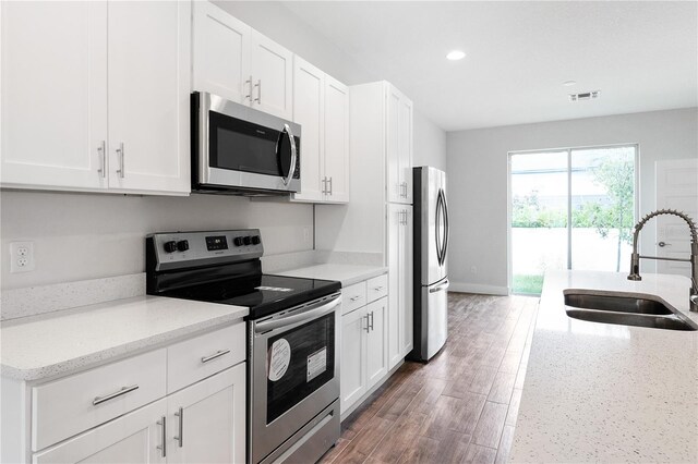 4409 Summer Flowers Pl, Kissimmee, FL 34746 - kitchen featuring visible vents, appliances with stainless steel finishes, white cabinetry, and a sink