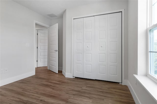 4409 Summer Flowers Pl, Kissimmee, FL 34746 - unfurnished bedroom featuring visible vents, wood finished floors, a closet, and baseboards