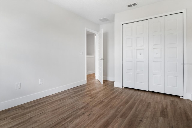 4409 Summer Flowers Pl, Kissimmee, FL 34746 - unfurnished bedroom with wood finished floors, visible vents, a closet, and baseboards